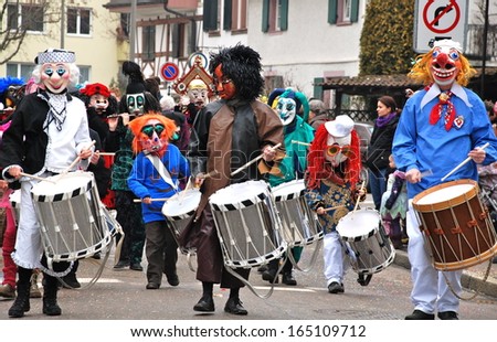 RIEHEN, SWITZERLAND - FEB 16: Carnival parade on February 16, 2012. A colorful parade of carnival masks in the town of Riehen revives a centuries old tradition of masked and costumed performances.