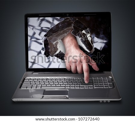 CONCEPT laptop with with broken screen the hand presses the button
