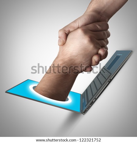 A hand comes right out of the laptop screen to shake hands CONCEPT. High resolution