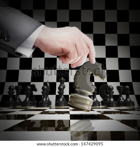 Strategy concept. hand holding white chess figure on chess board