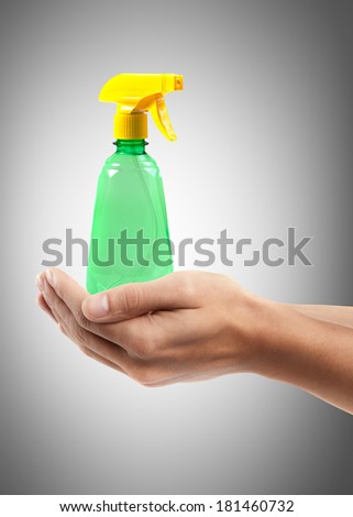 Man hand holding object ( green sprayer )  High resolution