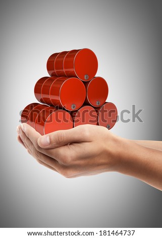 Man hand holding object ( red FUEL barrels ) High resolution
