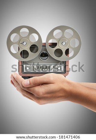 Man hand holding object ( Analog recorder reel to reel )  High resolution