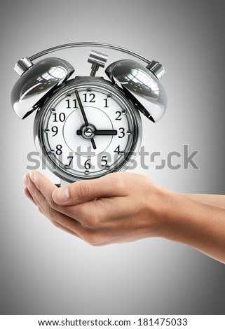 Man hand holding object ( Old-fashioned alarm clock ) High resolution