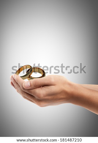 Man hand holding object ( Gold Wedding Rings )  High resolution