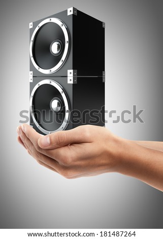 Man hand holding object ( black speakers ) High resolution