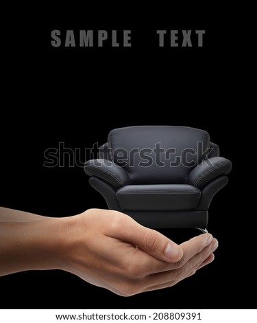 Man hand holding object ( modern leather chair ) isolated on black background. High resolution