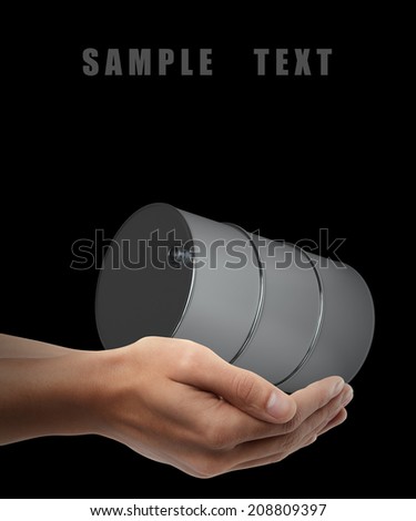 Man hand holding object ( FUEL barrels ) isolated on black background. High resolution