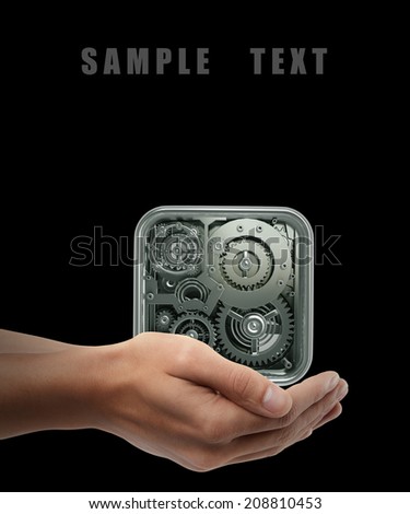gears box. Man hand holding object  isolated on black background. High resolution