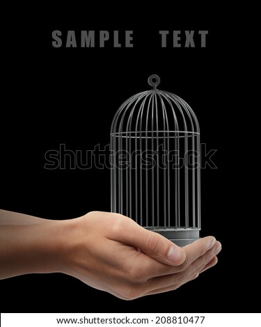 Bird cage. Man hand holding object  isolated on black background. High resolution
