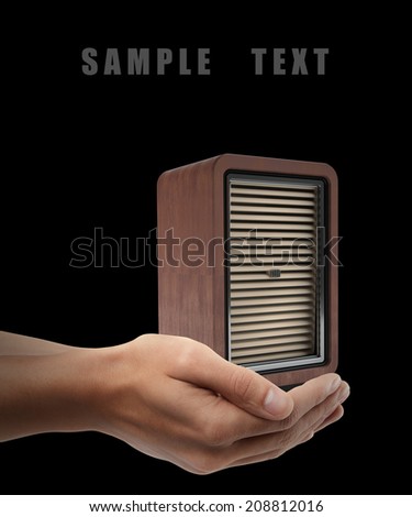 wooden music loudspeaker. Man hand holding object  isolated on back background. High resolution