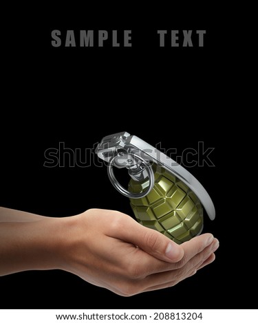 Grenade. Man hand holding object  isolated on black background. High resolution