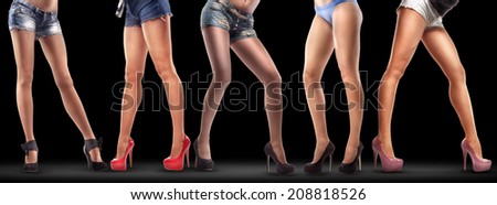 Lot of beautiful female legs isolated on black background. High resolution