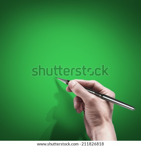 male hand with pen isolated on green background