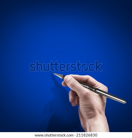 male hand with pen isolated on blue background