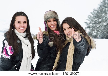 happy young girls are having fun in the snow