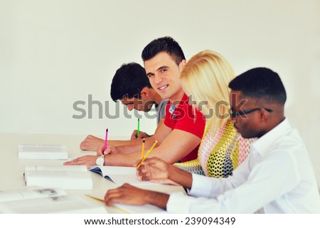 group of students studying together in a classroom
