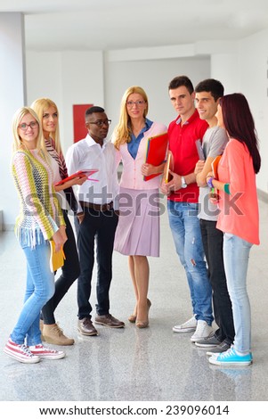 Professor and a student surrounded by a group of students holdin