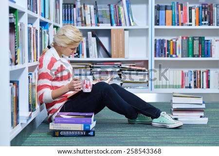beautiful female student learning in the library