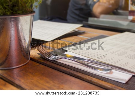 Restaurant table outdoors with menu and cutlery/Restaurant background/Dining out in London