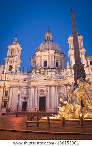 Fountain of the Four Rivers (1651) overlooked by the church of Sant\'Agnese in Agone in the beautifully Baroque Piazza Navona (1651) illuminated by pretty streelights.