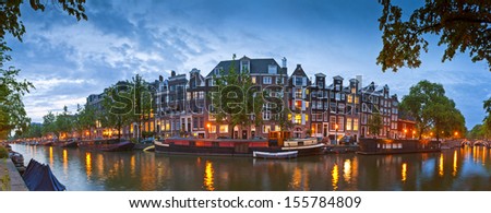 Pretty Night Time Illuminations Of Dutch Doll Houses Reflected In The Tranquil Canals Of Amsterdam.