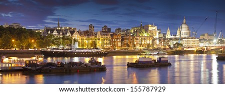 Pretty night time illuminations of the iconic architecture along the River Thames, many iconic sights visible, London, UK.