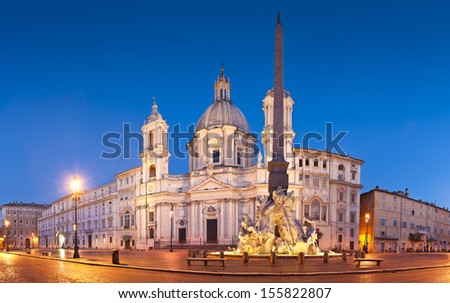 Fountain of the Four Rivers (1651) overlooked by the church of Sant\'Agnese in Agone in the beautifully Baroque Piazza Navona (1651) illuminated by pretty streelights.
