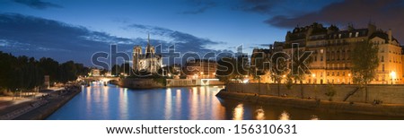 Pretty evening illuminations of the stunning Notre-Dame Cathedral (1163) and parisian apartments along the banks of the river Siene, Paris.