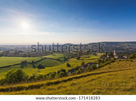 Idyllic Rural View Of Gently Rolling Patchwork Farmland And Villages With Pretty Wooded Boundaries, In The Beautiful Surroundings Of The Cotswolds, England, Uk.
