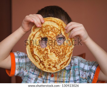 Boy is eating pancake