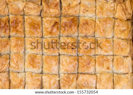 Fourthy pieces of baklava just came out from the owen and waiting to be consumed, shot from above, baklava background