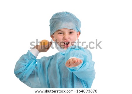 Third grade mischievous elementary kid looking at you and throws his bouncy egg project to see if really bounces, he is wearing blue scrubs