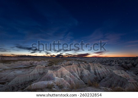 Scenic landscape of the constellation of Ursa Major, or Big Bear, over eroded mountains in the badlands of South Dakota in a starry evening sky