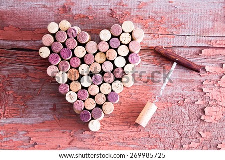 Close up Corks in Heart Shape and Wine Bottle Opener on Top of a Rustic Wooden Table for Love Concept. Captured in High Angle View.