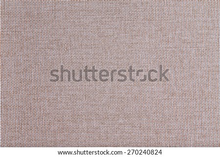 Background texture of coarse woven beige fabric with an open mesh weave of natural fibers in a full frame view