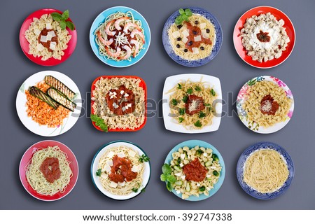 Top down view on twelve square and circular plates filled with various types of pasta topped with choice meats, fish, herbs, marinara sauce, cheese and other delicious ingredients