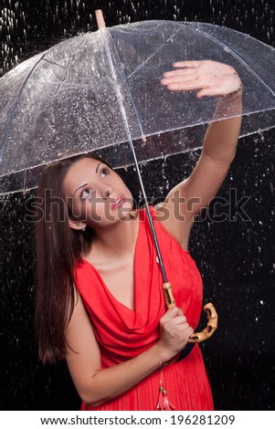 girl in a red dress in the rain. . umbrella