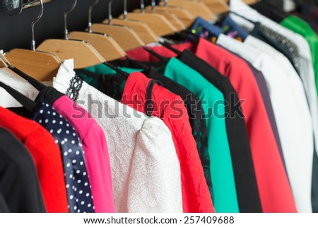 women\'s dresses on hangers in a retail shop