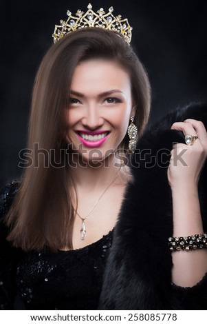 Beauty model woman wearing fur coat, diamond crown