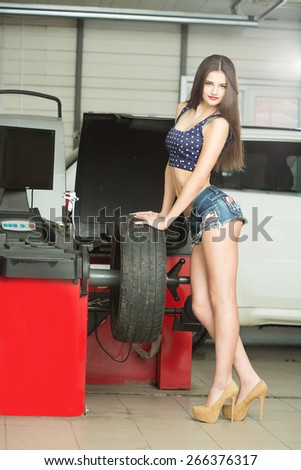 girl mechanic replace tires on wheels