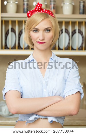 Beautiful pin-up girl on a kitchen. Retro style. Fashion.