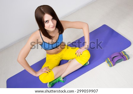 happy cutie athletic girl ,  execute exercise on muscles belly  and smile