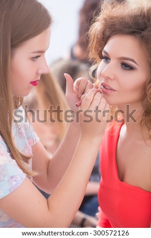 Professional Make-up artist doing glamour model makeup at work