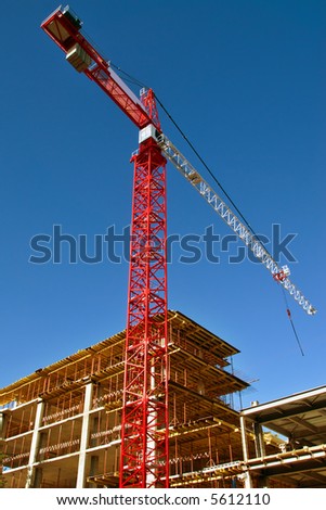Tall red crane on Construction site
