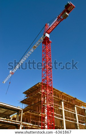 Tall red crane on Construction site