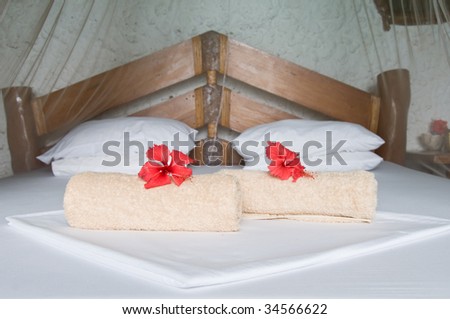 Welcoming Bed with Fresh Towels and Flowers