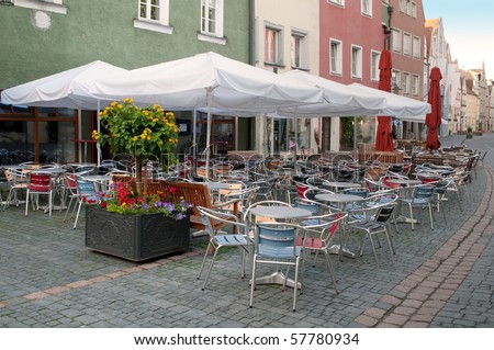 Coffee tables with umbrellas near cafe on European street, Weiden, Bavaria, Germany