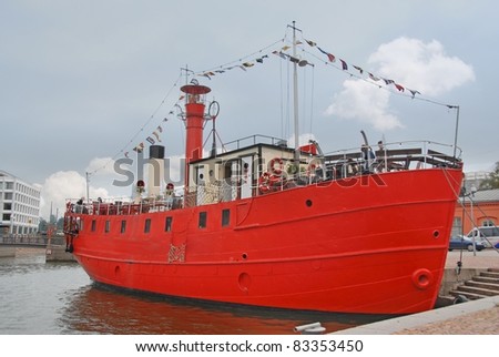 Red transport boat in the harbor in Helsinki, Finland