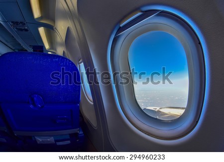 Airplane Window in flight with view to the skies